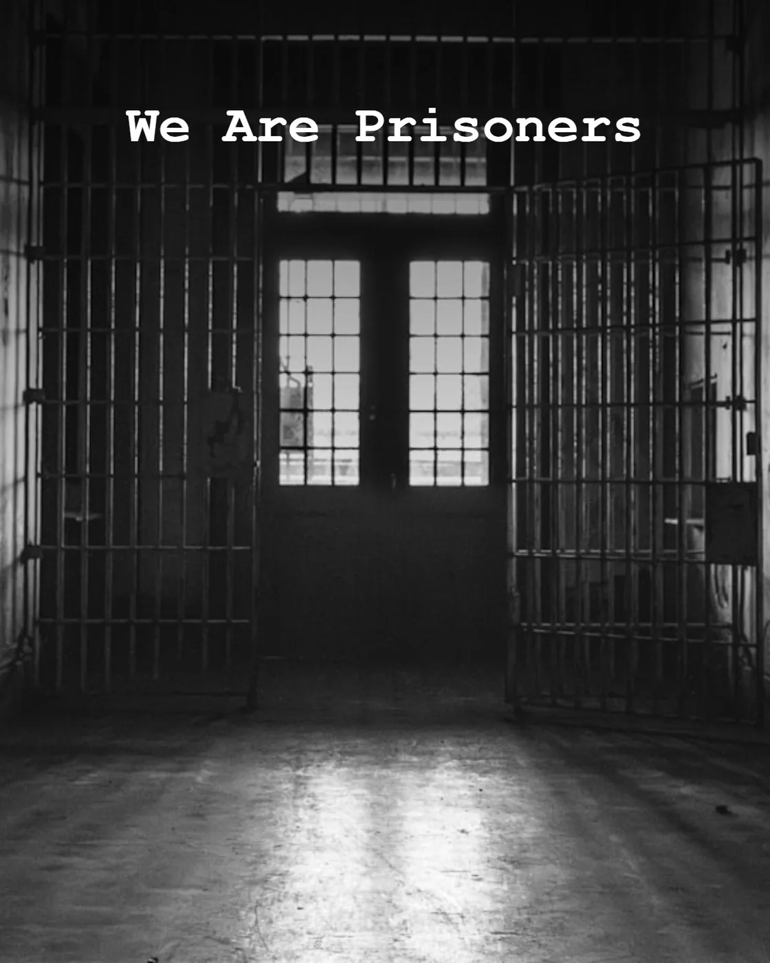 A dark, empty prison hallway with cell doors open.