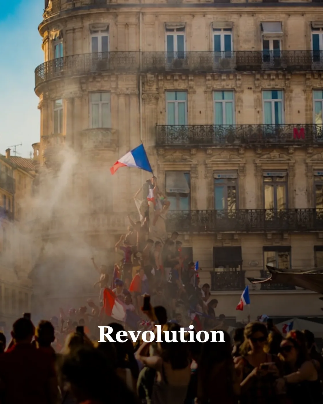 people waving flag of France near building