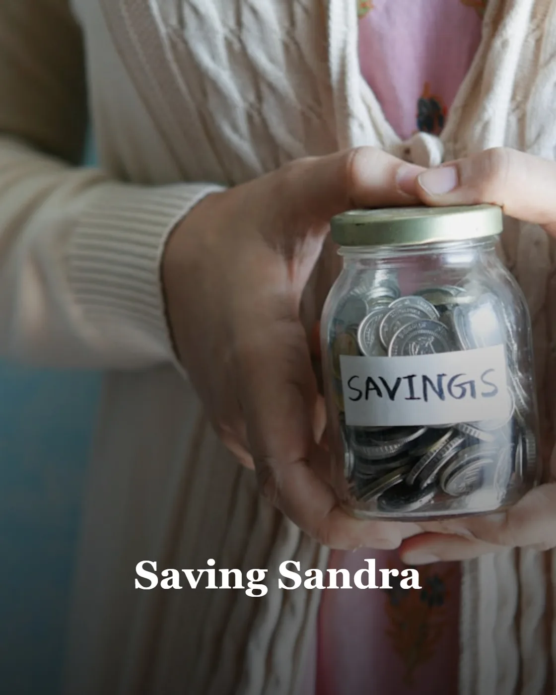 a woman holding a jar with savings written on it