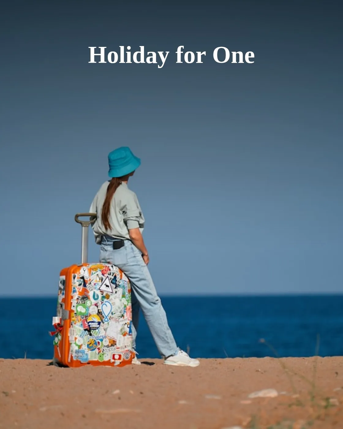 a woman standing on a beach with a suitcase