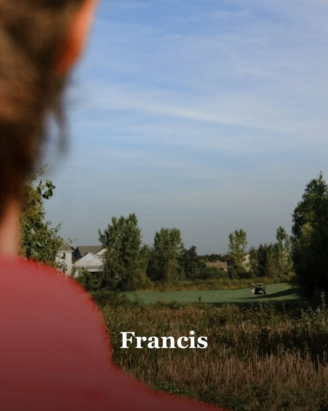 a woman in a red shirt is flying a kite